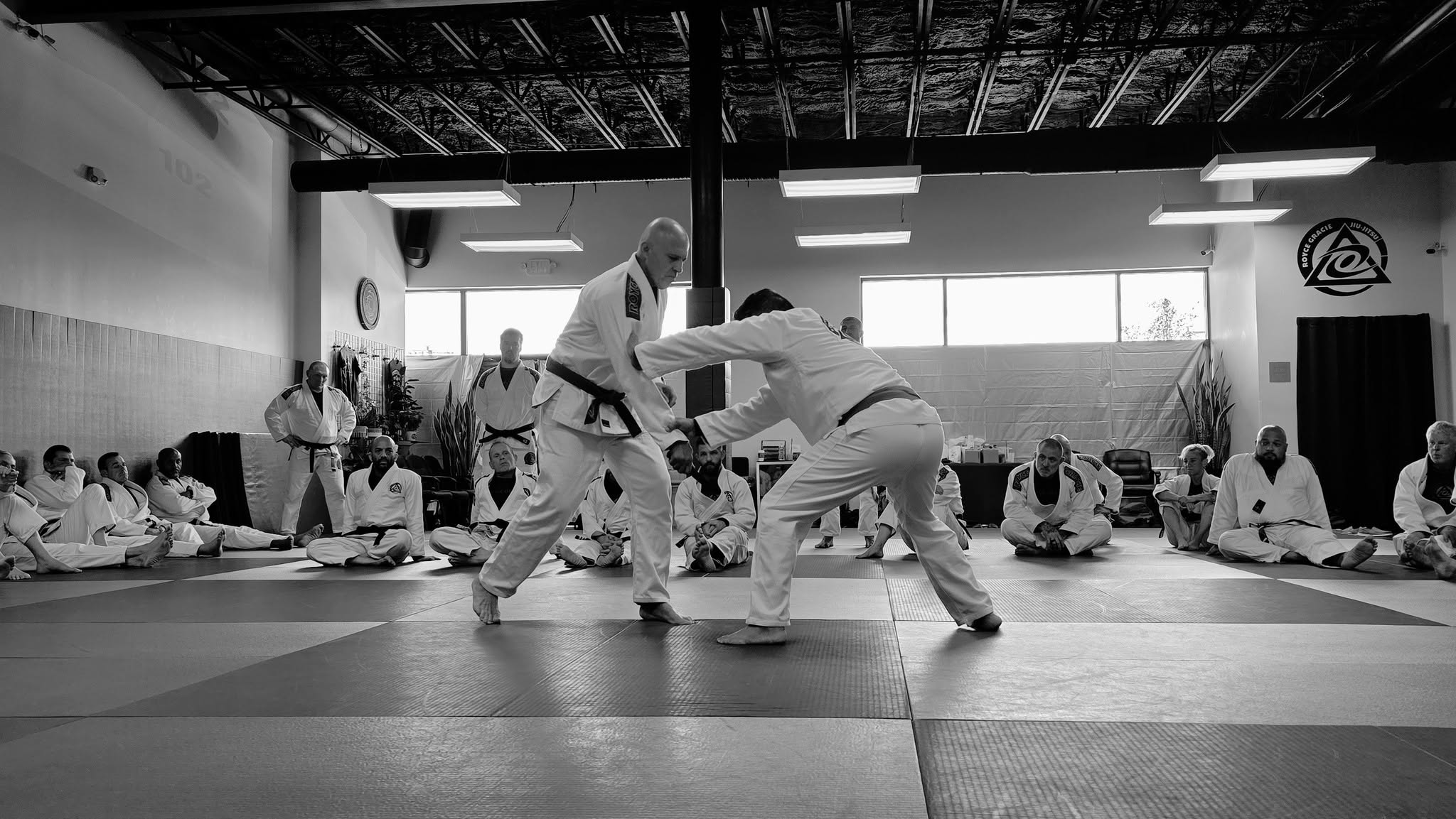 Royce Gracie demonstrating Jiu-Jitsu while students watch